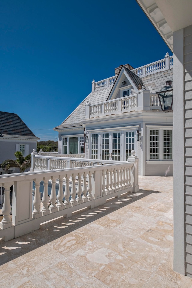 view of patio featuring french doors and a balcony