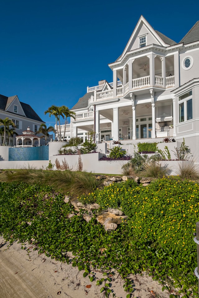 rear view of property featuring a balcony