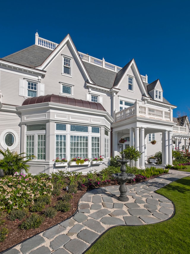 back of property with a balcony