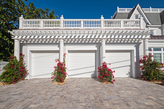 view of front of home featuring a garage and a balcony