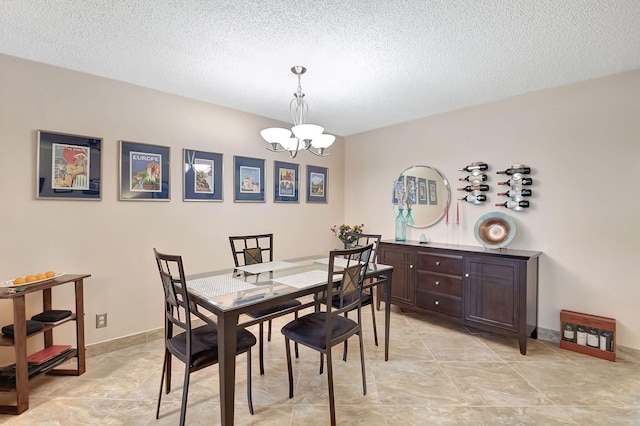 dining room featuring a textured ceiling and a notable chandelier