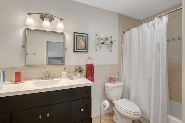 full bathroom with vanity, toilet, tile walls, and shower / tub combo