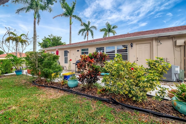 exterior space featuring a lawn and central air condition unit