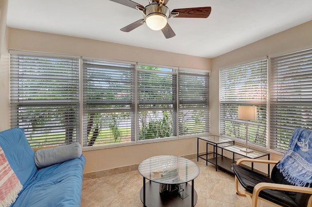 sunroom / solarium featuring a wealth of natural light and ceiling fan