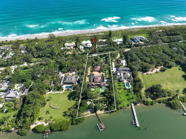 aerial view with a water view and a beach view