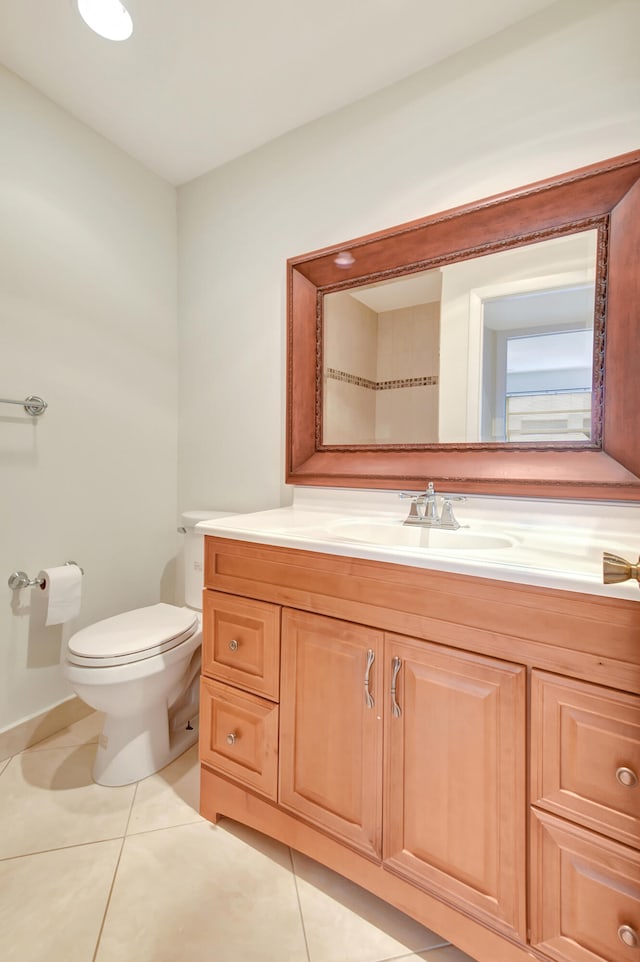 bathroom featuring tile patterned flooring, vanity, and toilet