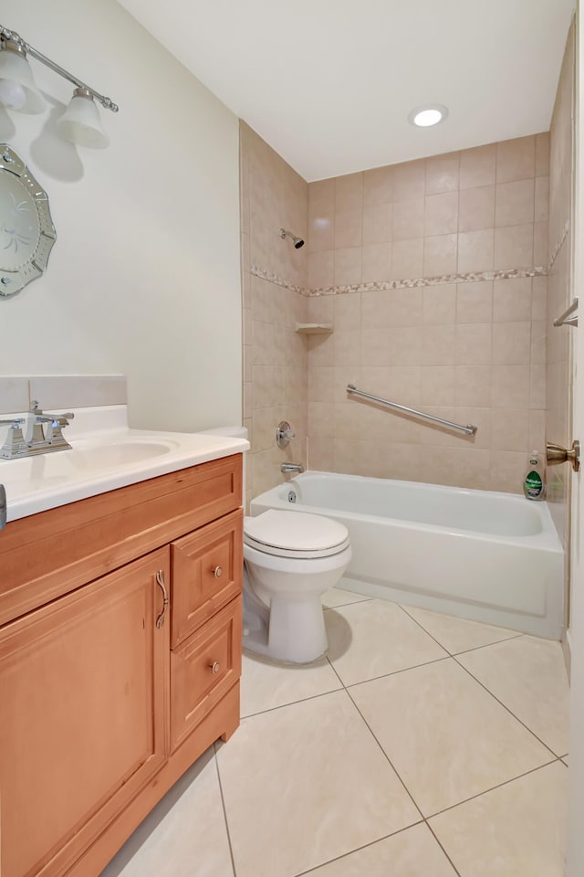 full bathroom featuring vanity, tiled shower / bath combo, tile patterned floors, and toilet