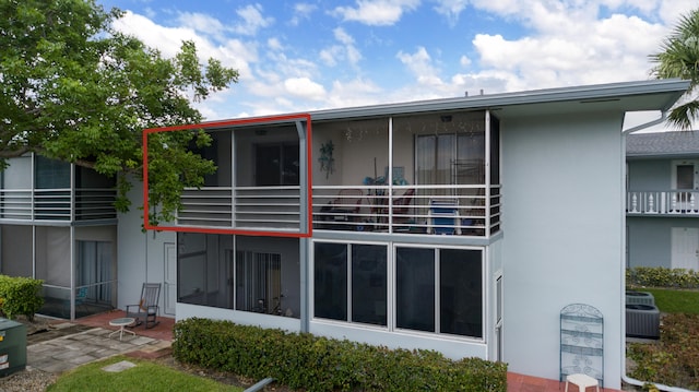 rear view of house featuring cooling unit