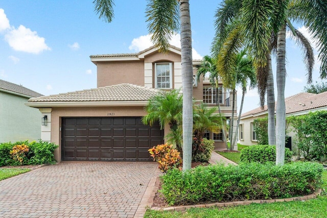 mediterranean / spanish-style home with a balcony and a garage