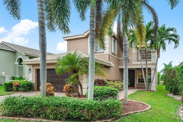 view of front facade with a garage and a balcony