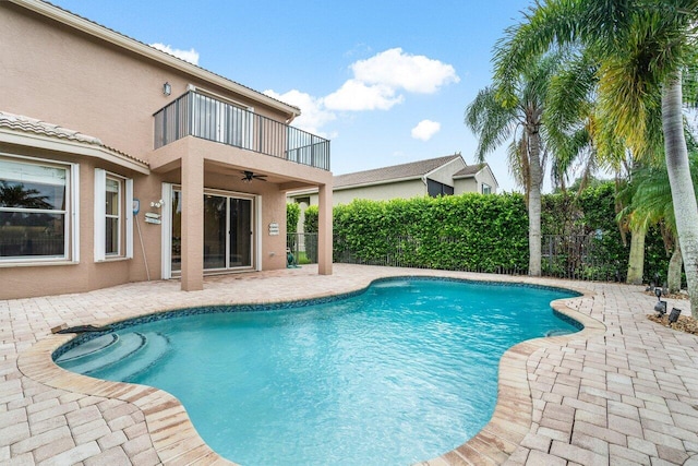 view of swimming pool featuring a patio area and ceiling fan