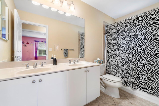 full bathroom with tile patterned flooring, vanity, toilet, and shower / tub combo