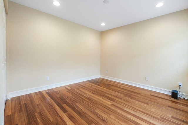 spare room featuring wood-type flooring