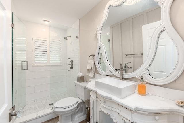 bathroom with vanity, toilet, and an enclosed shower