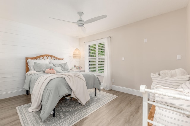 bedroom with ceiling fan and light hardwood / wood-style flooring