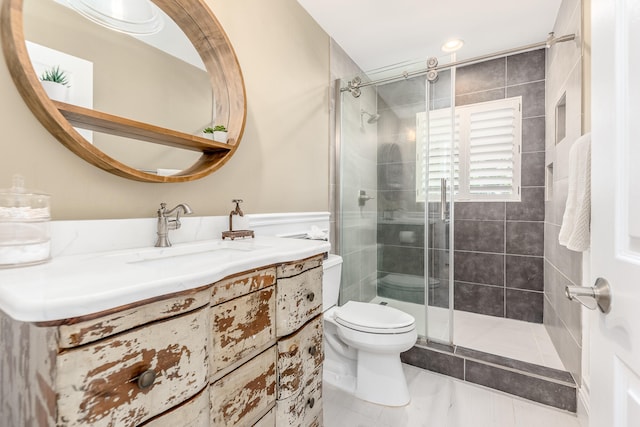 bathroom with tile patterned flooring, vanity, toilet, and a shower with door