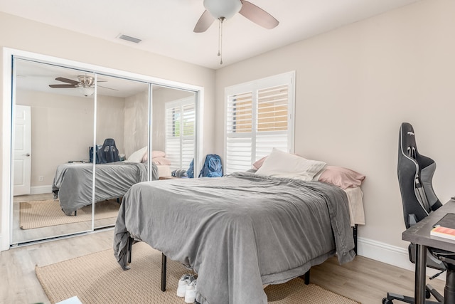 bedroom with a closet, ceiling fan, and light hardwood / wood-style flooring