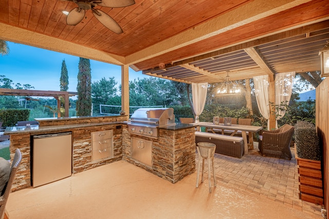 patio terrace at dusk with area for grilling, grilling area, and ceiling fan