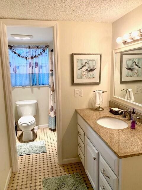 bathroom featuring walk in shower, vanity, a textured ceiling, and toilet