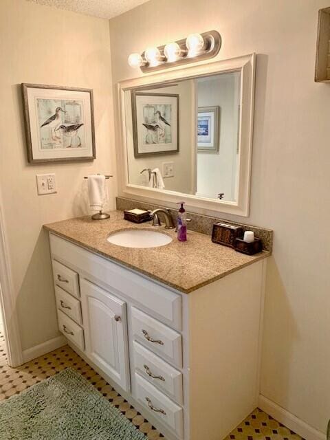 bathroom with a textured ceiling and vanity