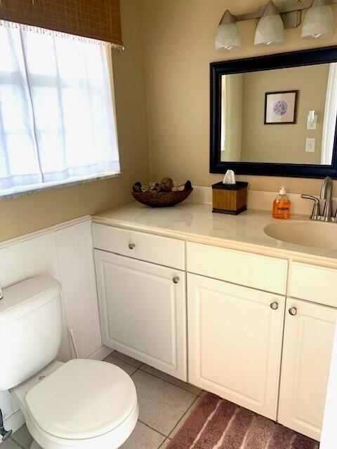 bathroom featuring tile patterned floors, vanity, and toilet