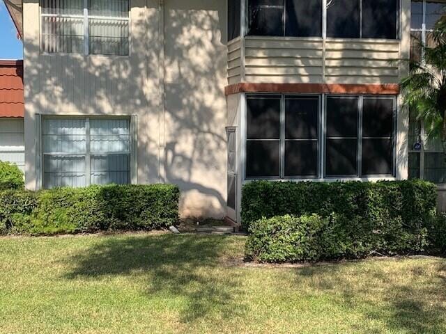 view of side of property with a lawn