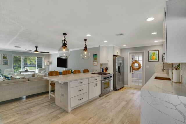 kitchen with sink, white cabinetry, dishwasher, light stone countertops, and backsplash