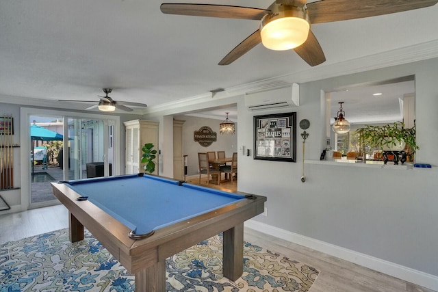 rec room featuring light wood finished floors, baseboards, crown molding, and a wall mounted air conditioner