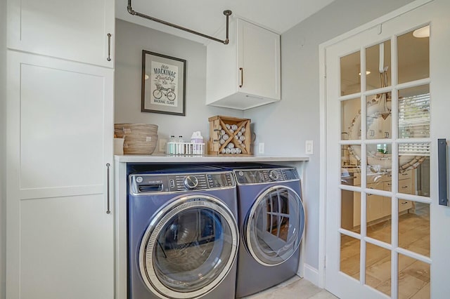 laundry area with cabinet space and independent washer and dryer