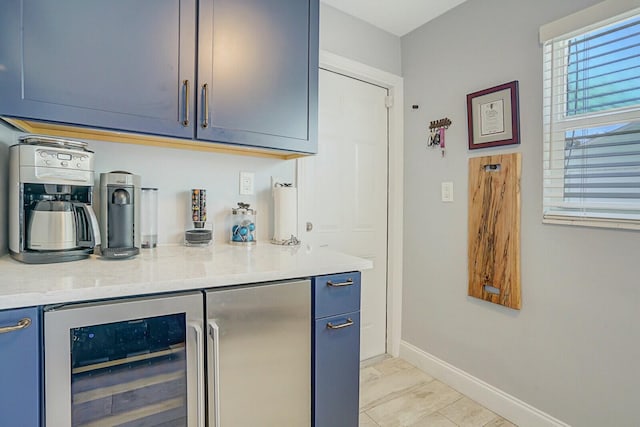 bar with wine cooler and baseboards