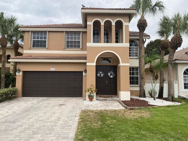 mediterranean / spanish house with a balcony and a garage