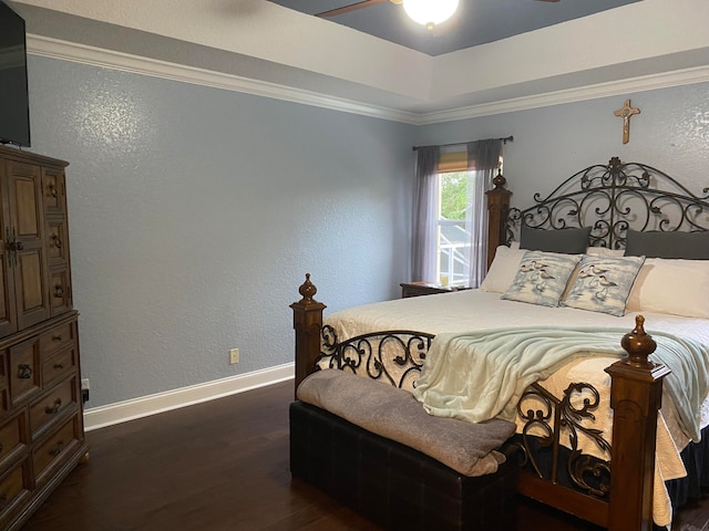 bedroom with dark hardwood / wood-style floors and ornamental molding