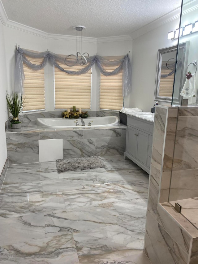 bathroom featuring a textured ceiling, vanity, a relaxing tiled tub, and crown molding