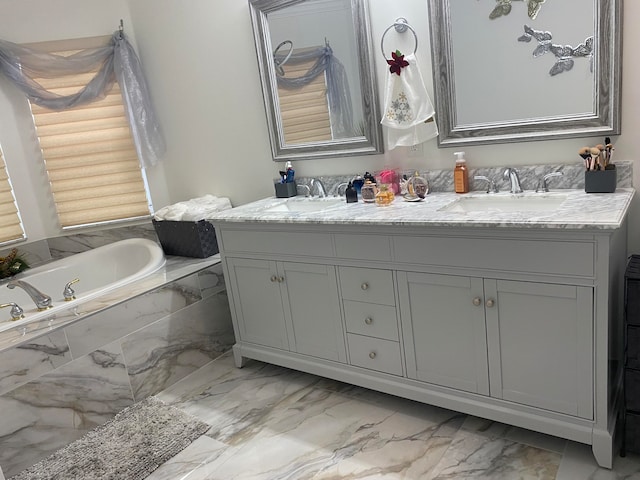 bathroom with tiled bath and vanity