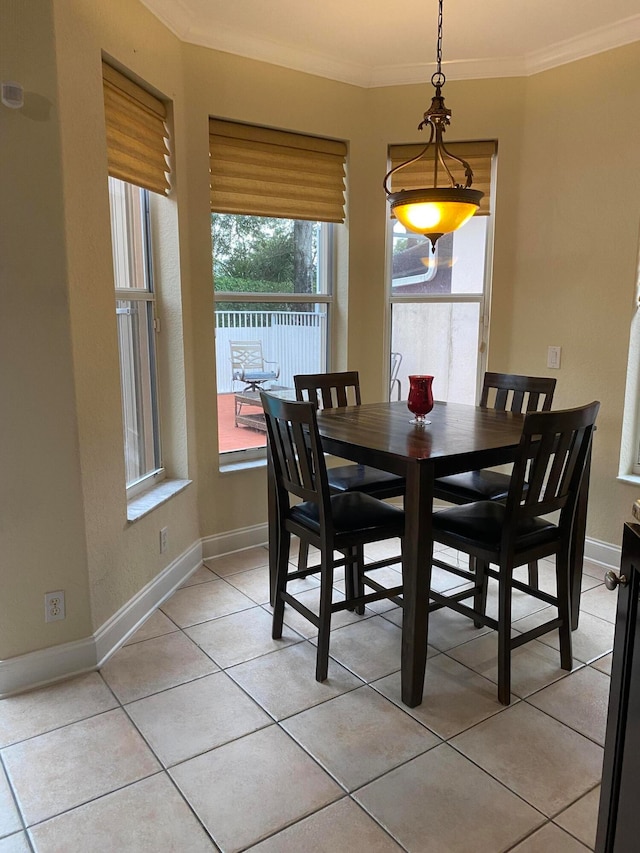 dining room with ornamental molding and light tile patterned floors