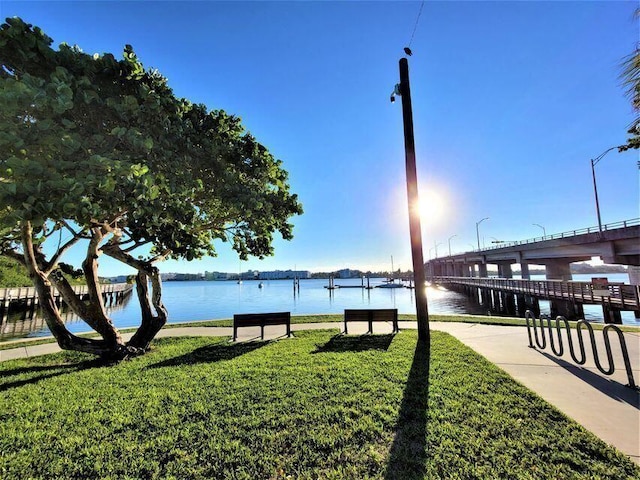 view of community featuring a yard and a water view