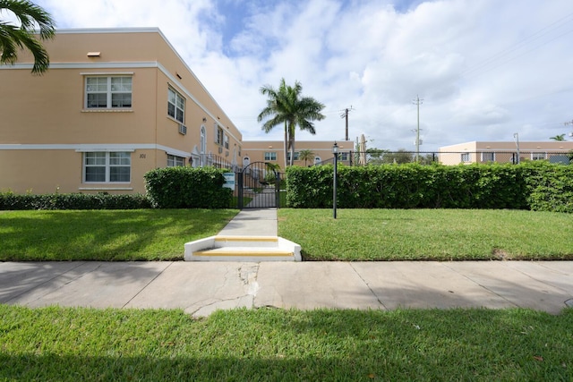 view of home's community with a yard