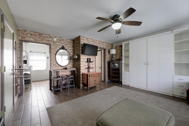 home office with dark hardwood / wood-style flooring and ceiling fan