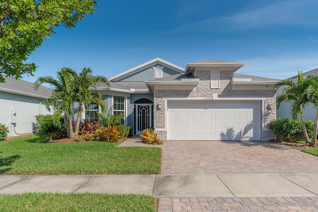 view of front of house with a front lawn and a garage