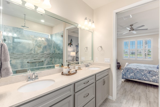 bathroom with a tile shower, vanity, hardwood / wood-style flooring, and ceiling fan