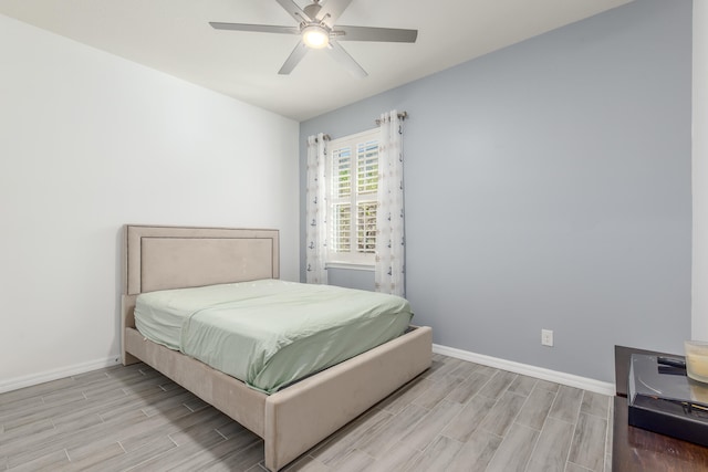 bedroom with light hardwood / wood-style flooring and ceiling fan