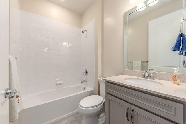 full bathroom featuring tile patterned floors, toilet, vanity, and tiled shower / bath