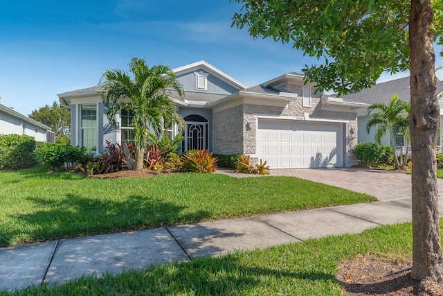 view of front of house with a front yard and a garage