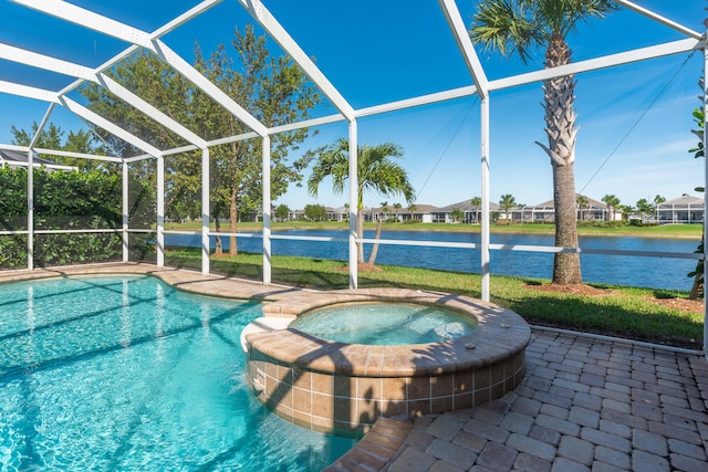 view of pool featuring glass enclosure, an in ground hot tub, a water view, and a patio