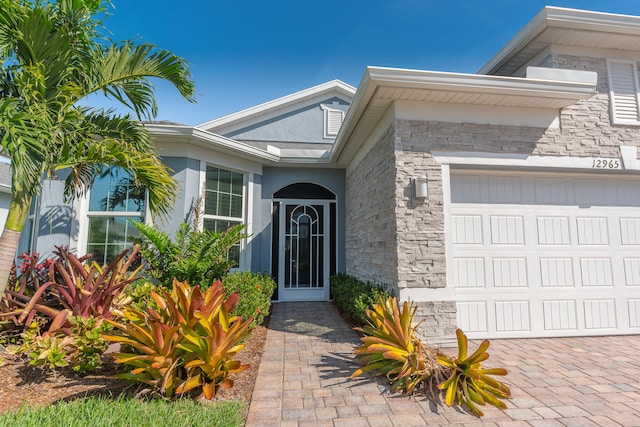 doorway to property with a garage