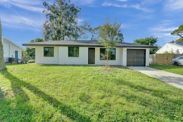 ranch-style home with a garage and a front lawn