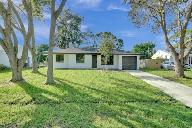 single story home with a garage and a front lawn