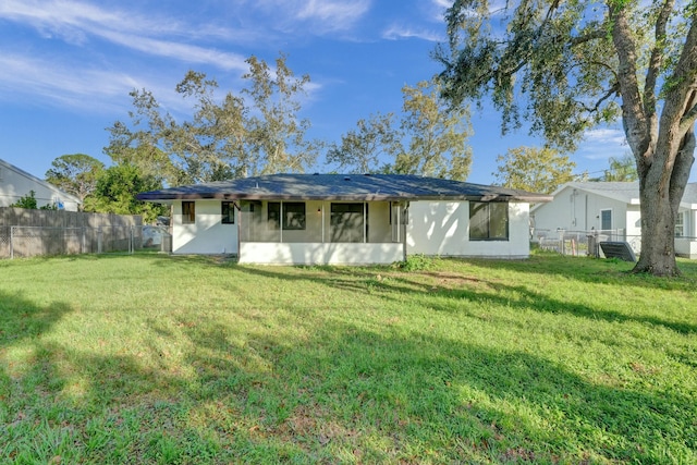 rear view of property featuring a yard