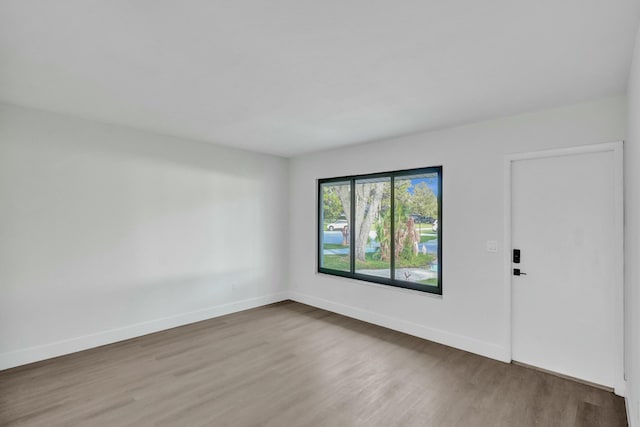 unfurnished room with hardwood / wood-style floors