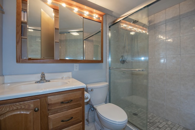 bathroom with vanity, toilet, and an enclosed shower